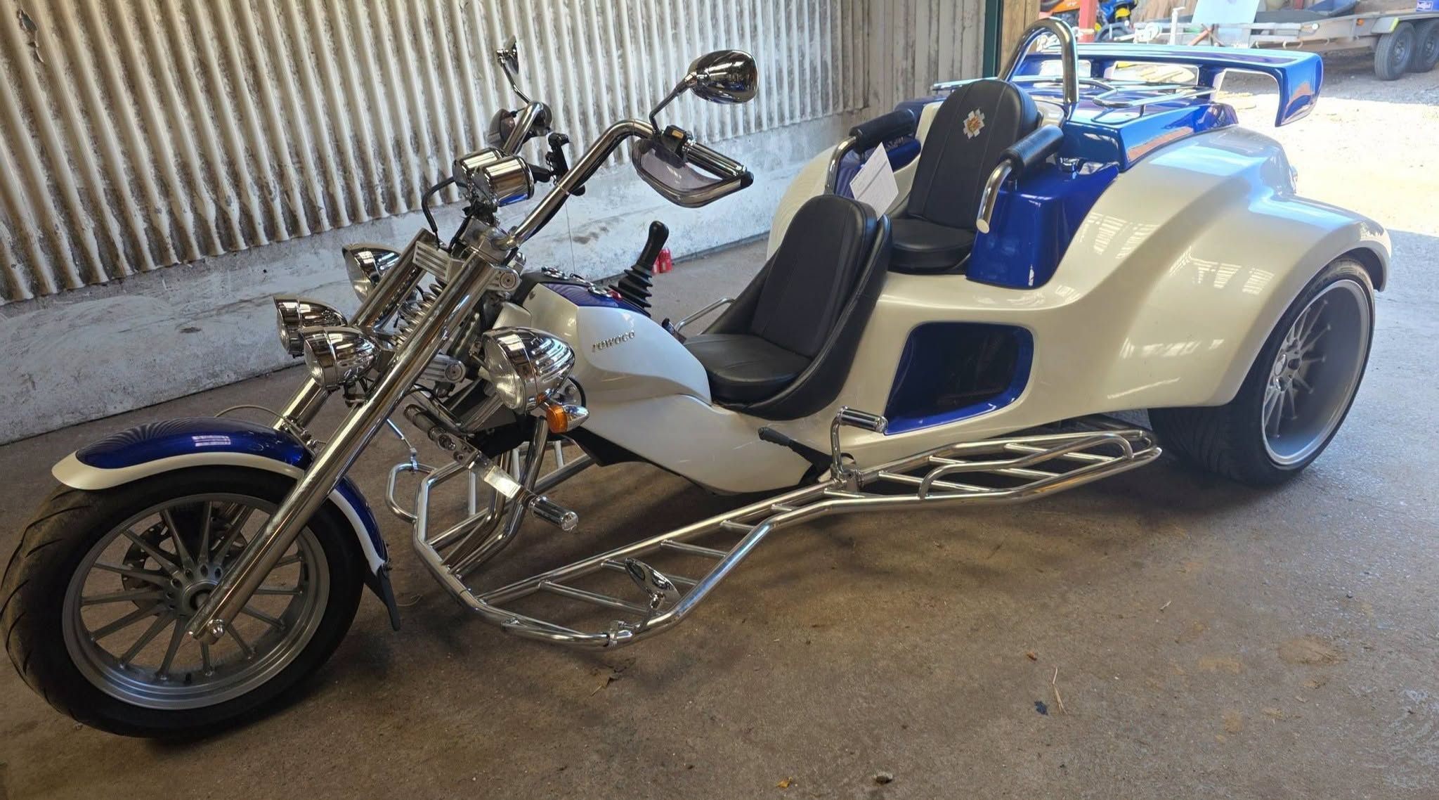 Finished blue and white custom trike in the workshop