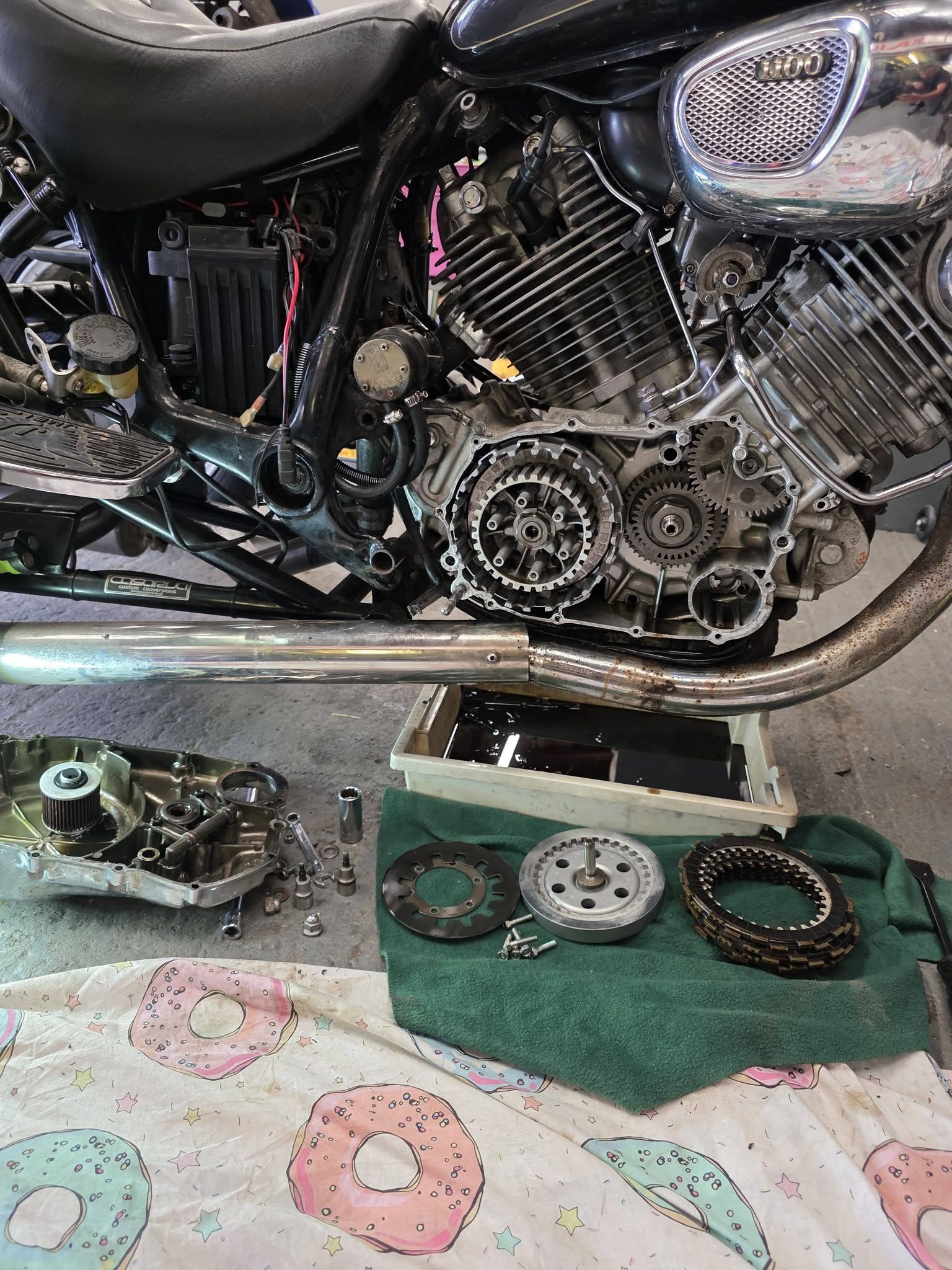 Motorcycle clutch and engine work with parts laid out
